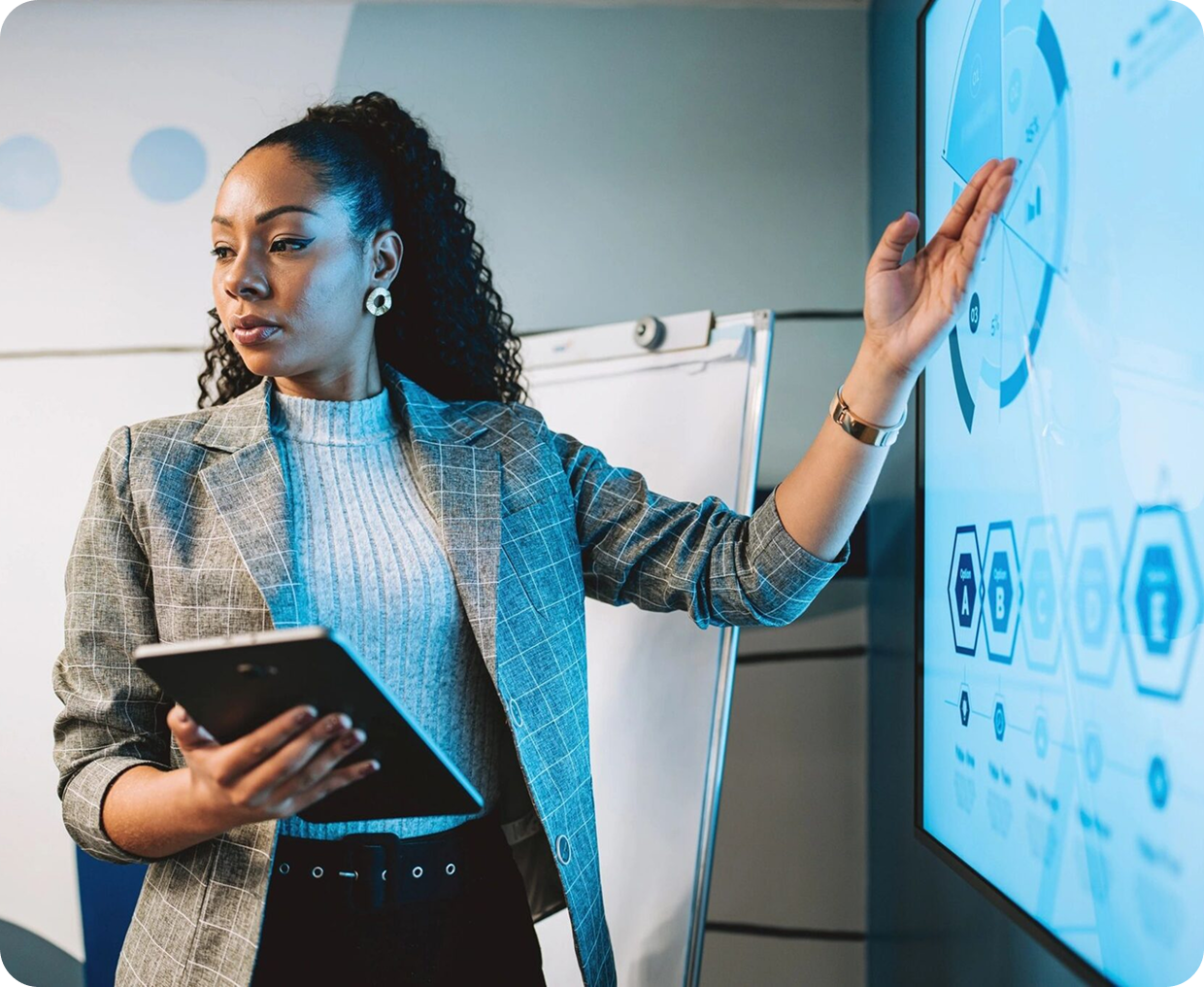 Woman presenting data on a digital screen.