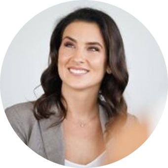 Smiling woman in a gray blazer.
