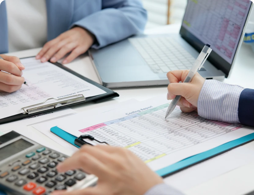 People working with documents and calculator.
